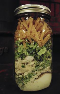 a mason jar filled with french fries and broccoli