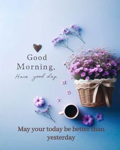 a basket filled with flowers next to a cup of coffee on top of a blue surface