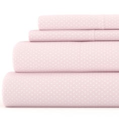 pink sheets with white polka dots are stacked on top of each other in three rows