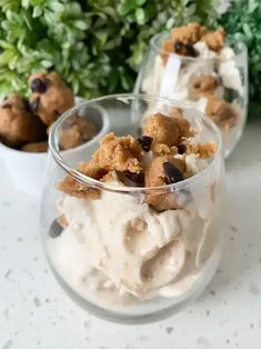 two glasses filled with ice cream and chocolate chips on top of a white countertop