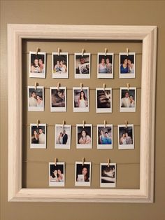 a white frame with photos hanging on clothes pins