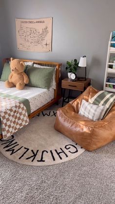 a child's bedroom with a teddy bear sitting on the bed and other furniture