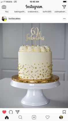 a white and gold birthday cake with the number 80 on it's top tier