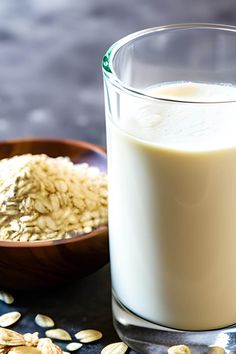 a bowl of oats next to a glass of milk