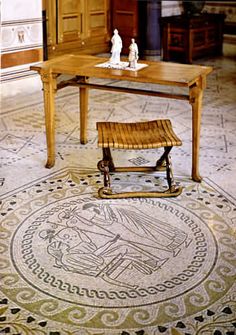 a wooden table sitting on top of a tiled floor