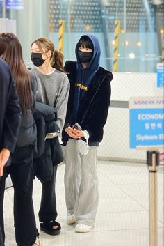 people wearing face masks at an airport