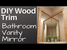 a bathroom vanity mirror with the words diy wood trim