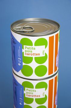 two cans of canned food sitting next to each other on top of a blue surface