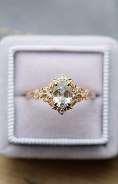 an engagement ring in a box on a table