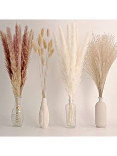 three vases with dried plants in them