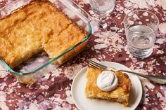 a piece of cake sitting on top of a white plate next to a glass dish