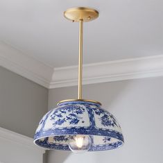 a blue and white lamp hanging from the ceiling