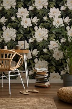 a chair and table in front of a floral wallpaper with white flowers on it