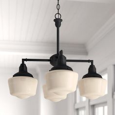 three lights hanging from a ceiling in a room