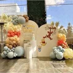 winnie the pooh balloon arch and decorations for a birthday party at disney's hollywood studios