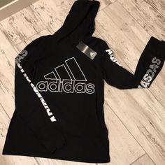 Black Adidas Long Sleeve, Hooded Shirt. T-Shirt Material. Brand New Cotton Sports Top With Hood, Black Hooded Tops For Athleisure, Letter Print Hoodie In Athleisure Style, Hip Hop Tops With Logo Print For Winter, Hip Hop Winter Tops With Logo Print, Black Hoodie Tops In Athleisure Style, Adidas Athleisure Tops For Winter, Athleisure Hoodie With Letter Print, Letter Print Hoodie Top Athleisure