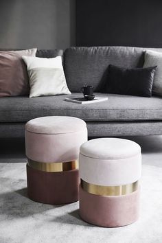 two stools sitting next to each other in front of a couch and coffee table