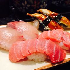 sushi on a plate with chopsticks and sauce