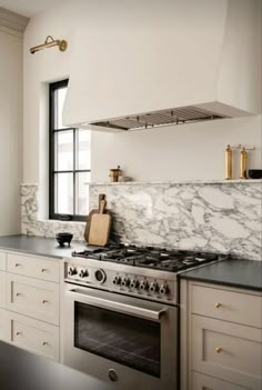 a stove top oven sitting inside of a kitchen