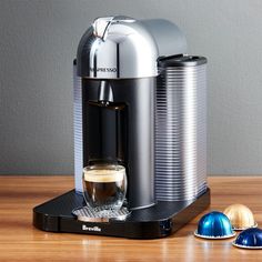 an espresso machine sitting on top of a wooden table