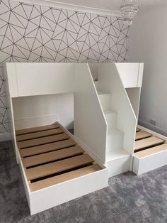 a white bunk bed with stairs built into the side and storage underneath it for extra space