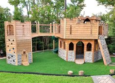 an outdoor play area with wooden structures and green grass