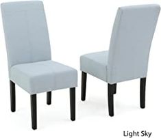 two blue chairs sitting next to each other on a white background, one with black legs