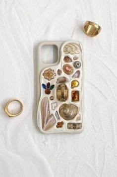 an iphone case with shells and rings on it