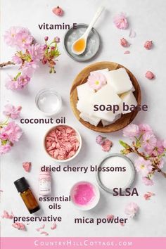 the ingredients to make homemade handmade soaps on a white surface with pink flowers