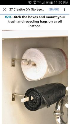 there is a roll of toilet paper on the wall next to two rolls of black towels