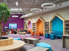 the children's library is brightly decorated with colorful bookshelves and seating areas