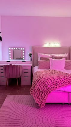 a bedroom with pink furniture and lights on the walls, along with a large bed