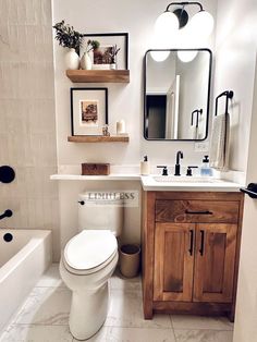 a white toilet sitting under a bathroom mirror next to a sink and bathtub in a bathroom