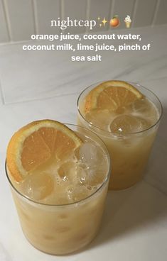 two glasses filled with orange juice and ice