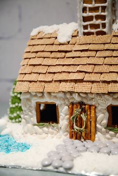 a gingerbread house made to look like it has snow on the roof