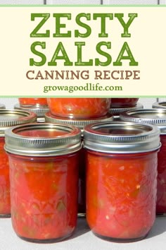 several jars filled with canned salsa sitting on top of a white countertop next to a sign that says zesty salsa canning recipe