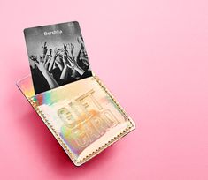 a credit card holder with an image of people holding their hands up in the air