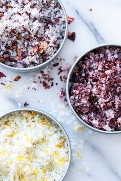 three bowls filled with different types of food on top of a marble countertop next to each other