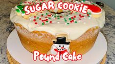 a cake with frosting and sprinkles on it that says sugar cookie pound cake