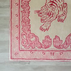 a pink and white rug with a tiger on it