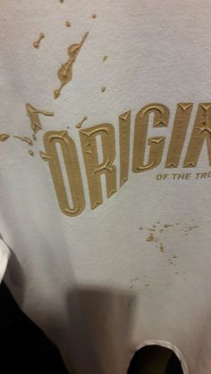 a white t - shirt with the word origin on it