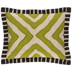 a green and white pillow with black stripes on the bottom, and an abstract design in the middle