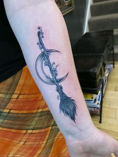 a woman's arm with a tattoo on it and an arrow in the middle