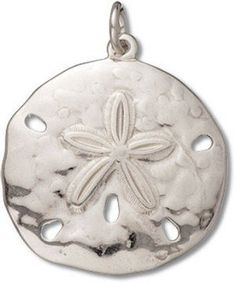 a silver sand dollar charm with a starfish on the front and two holes in the middle