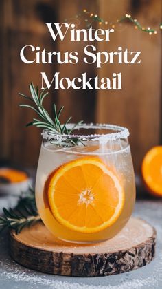 an orange and rosemary drink in a glass with the words winter citrus spritz mock cocktail