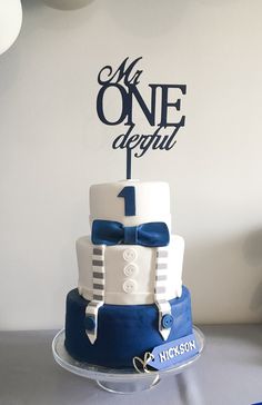 a blue and white cake with a one - tiered cake topper on it