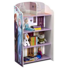 a book shelf with dolls and books on it