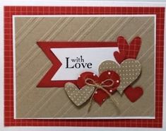 a close up of a card with hearts on it and a ribbon in the middle