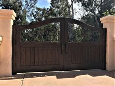 a large wooden gate in front of a house