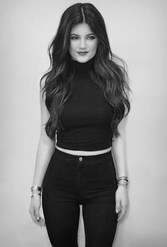 black and white photograph of a woman in high waisted jeans with her hair down